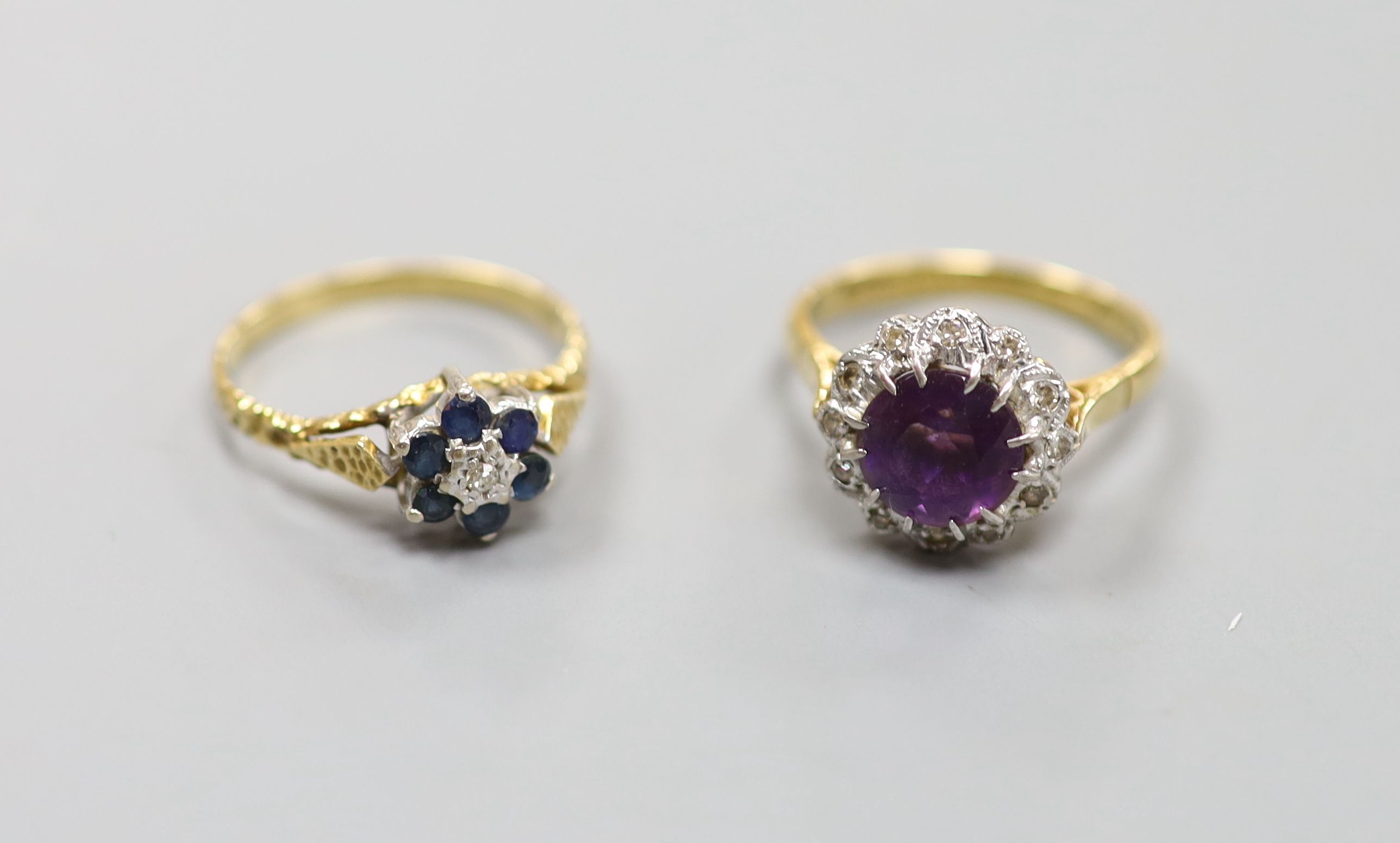 An 18ct yellow gold, diamond and amethyst cluster ring and an 18ct yellow gold, sapphire and diamond flower head ring, 7.1g